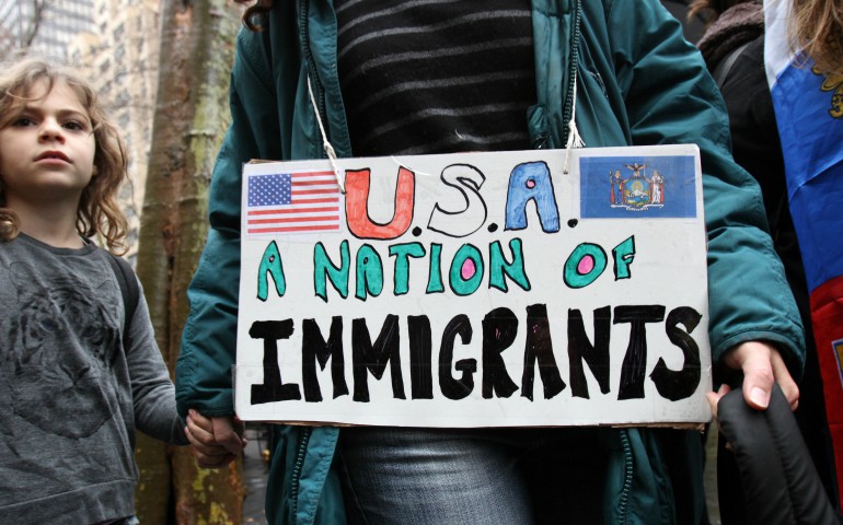 A woman holds a child's hand as they arrive for a rally in support of immigrants' rights in New York City Dec. 18, 2016. (CNS photo/Gregory A. Shemitz)