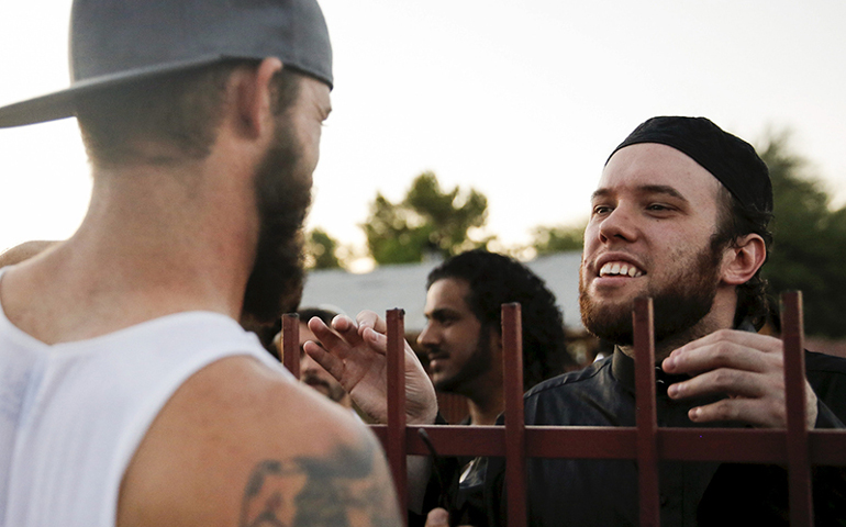 Ilyas Wadood, right, of the Islamic Community Center in Phoenix talks with a demonstrator during the "Freedom of Speech Rally Round II" on May 29, 2015. More than 200 protesters, some armed, berated Islam and its Prophet Muhammed outside the mosque that day in a provocative protest that was denounced by counterprotesters shouting "Go home, Nazis." (Photo courtesy of Reuters/Nancy Wiechec)