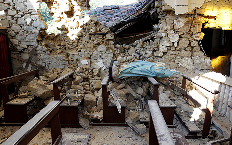 A damaged Virgin Mary statue is seen in a church following an earthquake at Cossito in central Italy, on Aug. 26, 2016. (Photo courtesy of Reuters/Max Rossi)