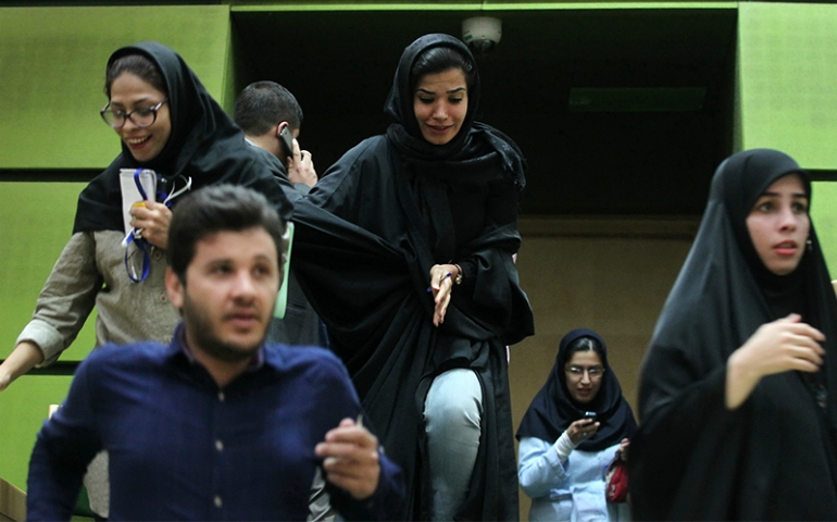 People run inside the Iranian Parliament building during an attack in central Tehran, Iran, on June 7, 2017. (Courtesy of TIMA via Reuters)