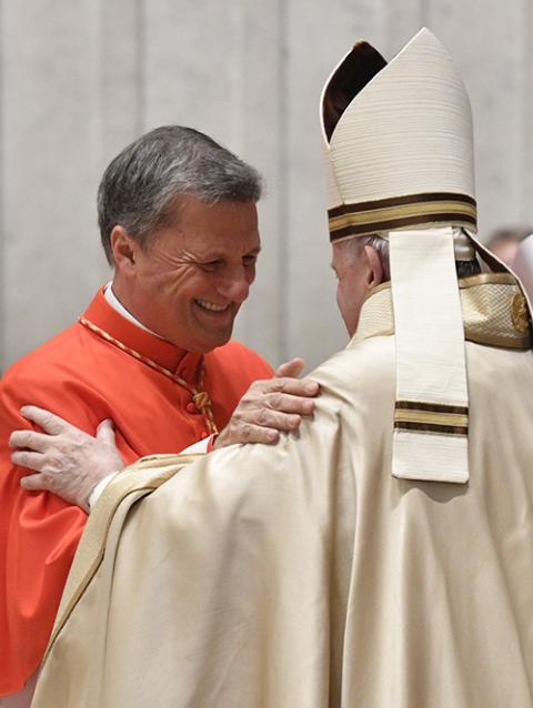 Pope Francis greets new Cardinal Mario Grech during a consistory for the creation of 13 new cardinals in St. Peter's Basilica at the Vatican Nov. 28, 2020. (CNS/Vatican Media)