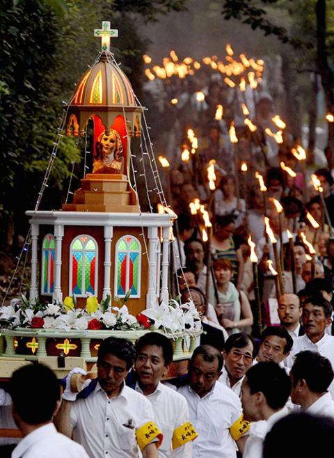 People carry the remains of a statue of Mary that survived the Nagasaki atomic bomb as they march through the streets of the city Aug. 9, 2012. Several U.S. bishops are undertaking a "Pilgrimage of Peace" to Hiroshima and Nagasaki, to advocate for nuclear disarmament. (OSV News/Kyodo, Reuters)