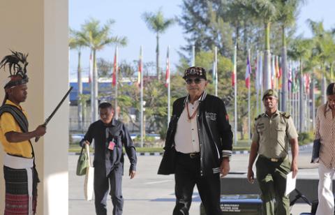 President of East Timor, Jose Ramos-Horta, Dili, East Timor, Sept. 4, 2024. President Ramos-Horta wears casual clothes, waling into palace, palm trees in background.