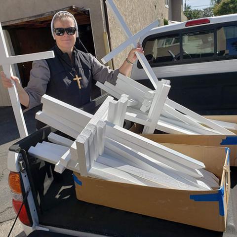 Felician Sr. Maria Louise Edwards, a board member of Aguilas del Desierto, shows the crosses her group uses to mark the places where the search and rescue organization recovers the bodies of people who have attempted to travel through the desert to cross the southern border into the United States. (Courtesy of Aguilas del Desierto)