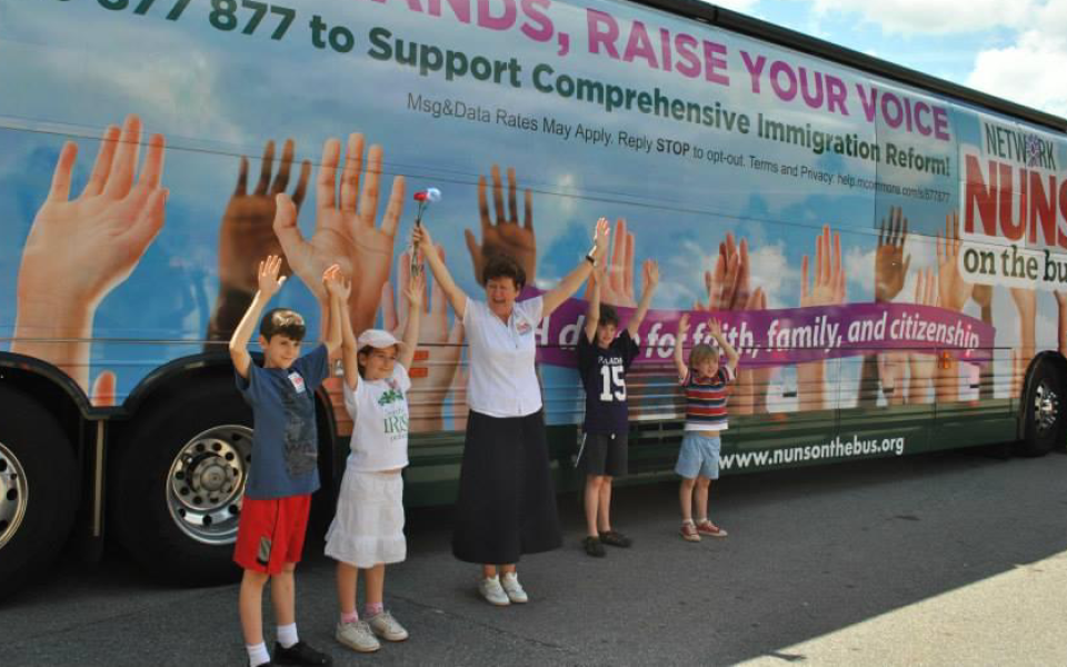 Sr. Mary Ellen Lacy stands outside Network's bus during the 2013 Nuns on the Bus tour for immigration reform.