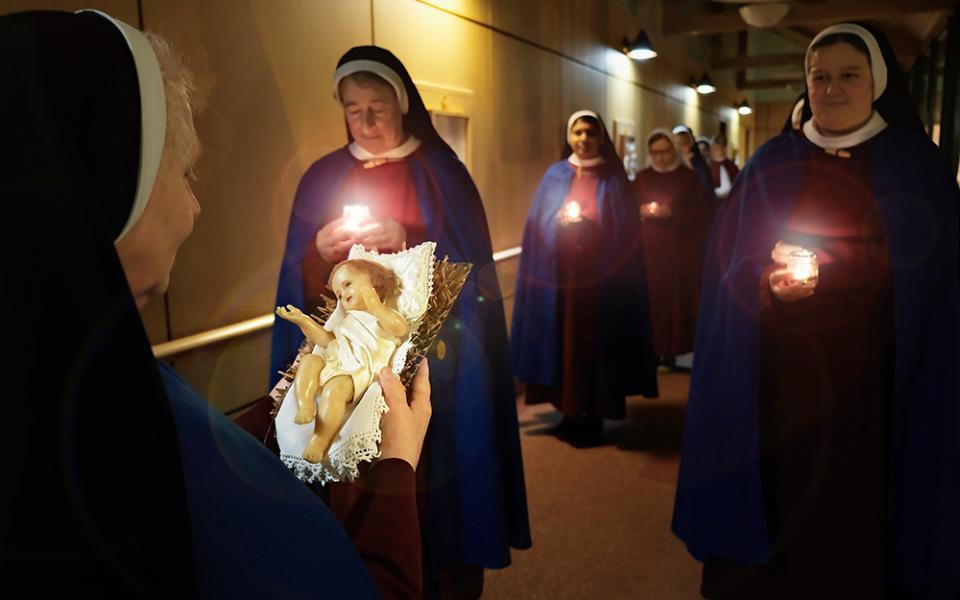 On Christmas Eve a candlelight procession carries the Child Jesus through every corner of the Sisters of the Most Holy redeemer in Dublin, Ireland, where he is reverently welcomed with a kiss — a moving preparation for the Christmas vigil. (Courtesy of Angela Cameron)