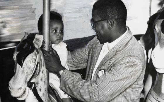 The Baltimore Sun photo of 11-month-old Sharon Langley and her father on the carousel at Gwynn Oak Amusement Park on Aug. 28, 1963, in Baltimore. (©Hearst Communications, Inc.)