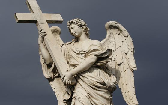 A statue of an angel carrying Christ's cross is seen on the Castel Sant'Angelo bridge in Rome. (CNS/Paul Haring)