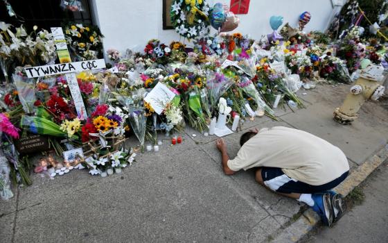 A man pays his respects outside Emanuel African Methodist Episcopal Church in Charleston, South Carolina, June 21, 2015. Nine African-Americans were shot to death by Dylann Roof at an evening Bible study inside the church June 17, 2015. (CNS/Brian Snyder)