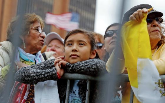 People waiting outside to hear Pope Francis speak at Independence Hall watch on large screens as he celebrates Mass at the nearby cathedral basilica in Philadelphia Sept. 26, 2015. (CNS/Reuters/Jonathan Ernst)