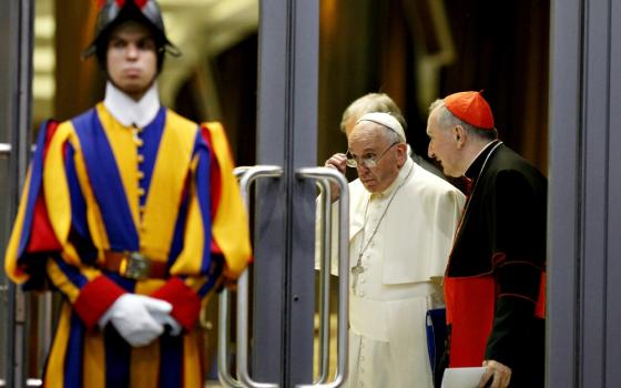 Pope Francis and Cardinal Pietro Parolin, Vatican secretary of state, talk as they leave the opening session of the Synod of Bishops on the family at the Vatican Oct. 5, 2015. (CNS/Paul Haring)