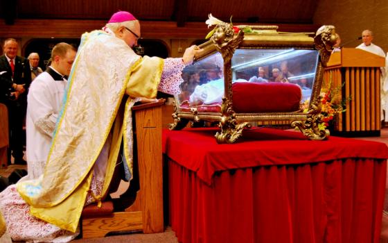 Bishop Robert Morlino of Madison, Wisconsin, venerates relics of St. Maria Goretti at St. Maria Goretti Church in Madison in 2015. (CNS/Catholic Herald/Kevin Wondrash)