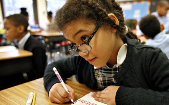 Third-grade student Elaine Chatman-Borowiec makes a valentine to send to a veteran as part of a Catholic Schools Week activity at St. Thomas the Apostle School in Chicago Feb. 2, 2016. (CNS/Catholic New World/Karen Callaway)