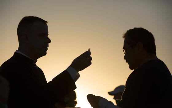 A man receives Communion on the U.S. side of the border in El Paso, Texas, Feb. 17, 2016, as Pope Francis celebrated Mass in Ciudad Juárez, Mexico. (CNS/Nancy Wiechec)