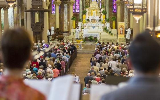 People pray during Mass April 17, 2016, at Holy Redeemer Church in Detroit. The Mass was the site of a "Mass Mob" event, an evangelization effort aimed at boosting regular Mass attendance. (CNS/Jim West)