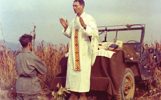 U.S. Army chaplain Father Emil Joseph Kapaun, who died May 23, 1951, in a North Korean prisoner-of-war camp, celebrates Mass from the hood of a jeep Oct. 7, 1950, in South Korea. (CNS/Courtesy of U.S. Army medic Raymond Skeehan)