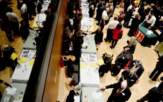 Jobseekers line up to meet with a prospective employer during a 2013 job fair in New York City. (CNS/EPA/Andrew Gombert)