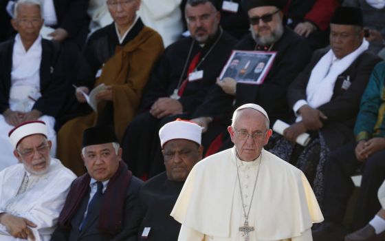 Pope Francis walks forward to speak during an interfaith peace gathering outside the Basilica of St. Francis in Assisi, Italy, Sept. 20, 2016. The Vatican announced June 17 that it will host faith leaders in October to prepare a statement ahead of the COP