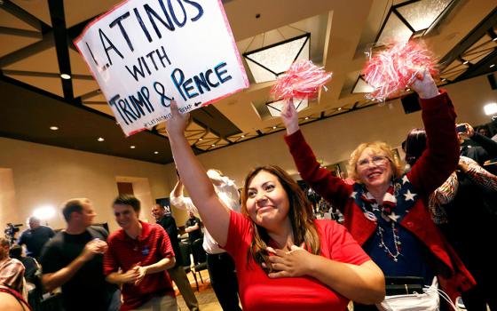 Attendees at a Republican Party event in Phoenix watch as President-elect Donald Trump gives his acceptance speech in New York in the early morning hours of Nov. 9, 2016. (CNS/Reuters/Nancy Wiechec)