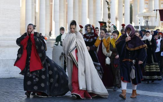 People in traditional attire endure cold weather during the annual parade marking the feast of the Epiphany in St. Peter's Square at the Vatican Jan. 6, 2017. (CNS photo/Paul Haring)