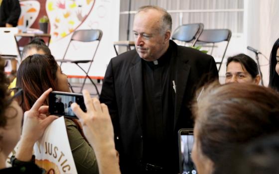 Bishop Robert McElroy of San Diego meets with Latino grassroots activists after his Feb. 18 talk at the U.S. Regional World Meeting of Popular Movements in Modesto, California. (CNS/Dennis Sadowski) 