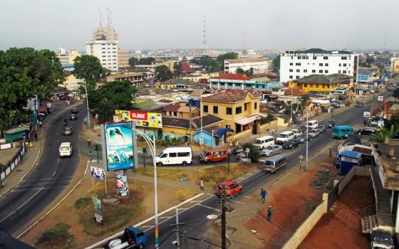 Cars and people travel through a business area in 2016 in Accra, Ghana. (CNS/Luc Gnago, Reuters)