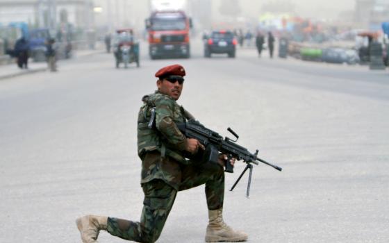 An Afghan soldier stands guard on a roadside in Ghazni, Afghanistan, April 22. (CNS/EPA/Ghulam Mustafa)