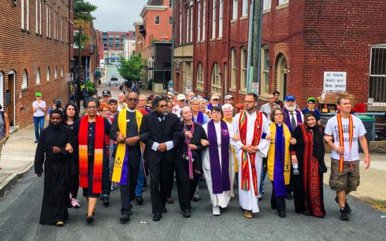 Eric Martin, first row far right, marches with clergy and faith leaders to counter protest the Unite the Right Rally in Charlottesville, Virginia, Aug. 12, 2018. (Photo by Jordy Yager)