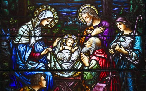 This stained-glass window at St. Aloysius Church in Great Neck, N.Y., depicts Jesus in a manger surrounded by Mary, Joseph and three shepherds. (CNS/Gregory A. Shemitz)