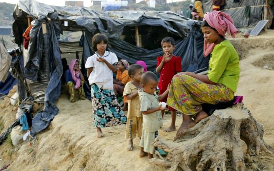 A Rohingya family sits outside their tent Nov. 20 at a refugee camp in Cox's Bazar, Bangladesh. (CNS/EPA/Abir Abdullah)