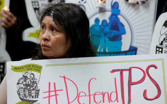 Salvadoran immigrant Mirna Portillo listens during a news conference Jan. 8 at the New York Immigration Coalition in Manhattan following President Donald Trump's announcement to end temporary protected status for Salvadorans. (CNS/Reuters/Andrew Kelly)