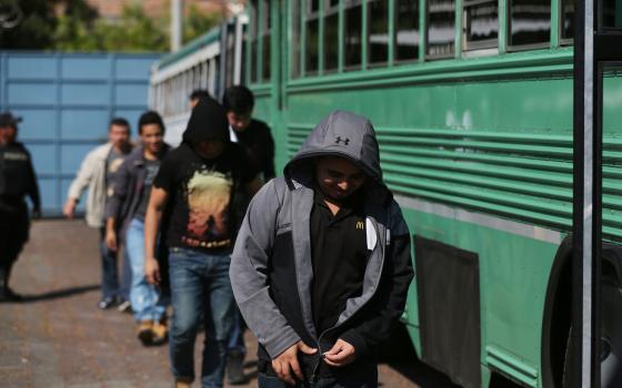 Deportees get off a bus at an immigration facility Jan. 11 after a flight arrived in San Salvador, El Salvador, with immigrants who were in the U.S. without documents. U.N. officials said Jan. 12 that U.S. President Donald Trump's reported use of an exple