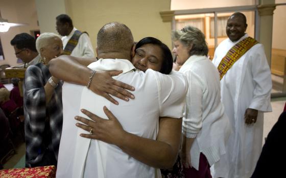 Worshippers exchange the sign of peace on the second evening of an African-American Catholic revival celebration Feb. 6 at St. Rita's Catholic Church in San Diego. (CNS/David Maung)