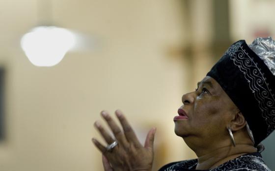 A woman prays on the second evening of an African American Catholic revival celebration Feb. 6, 2018, at St. Rita's Catholic Church in San Diego. (CNS/David Maung)