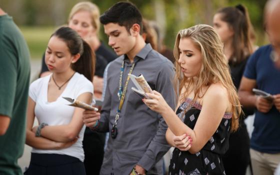 Parishioners of Mary Help of Christians Church in Parkland, Florida, pray during an outdoor Stations of the Cross service Feb. 16 dedicated to the victims and survivors of the deadly mass shooting at nearby Marjory Stoneman Douglas High School. (CNS)