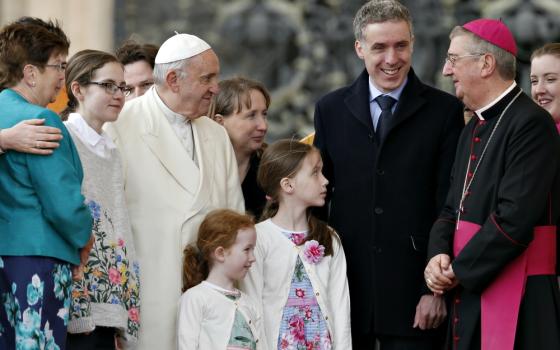 Pope Francis talks with Dublin Archbishop Diarmuid Martin as he meets an Irish delegation of families during his general audience in St. Peter's Square at the Vatican March 21. (CNS/Paul Haring)