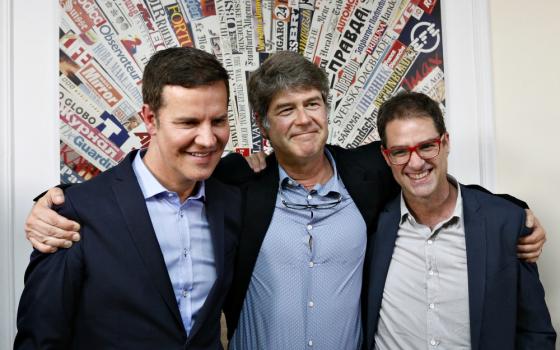 Chilean clerical sex abuse survivors Juan Carlos Cruz, James Hamilton and José Andrés Murillo embrace after speaking to the media at the Foreign Press Association building in Rome May 2. (CNS/Paul Haring)