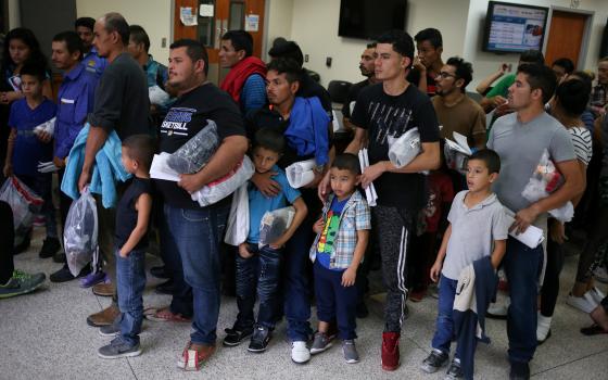 Immigrant families are released from detention July 27 at a bus depot in McAllen, Texas. (CNS/Loren Elliott, Reuters)