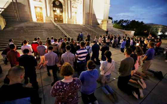 About 120 young adults kneel and pray at the Cathedral of St. Paul, Minnesota, Aug. 20 during a vigil called "Evening Prayer for the Survivors of Clerical Abuse and the Healing of the Church." (CNS/The Catholic Spirit/Dave Hrbacek)