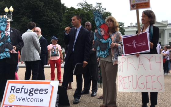 Catholics join other religious organizations and groups near the White House in Washington Sept. 12 urging the administration to allow 75,000 refugees into the country next fiscal year. (CNS/Rhina Guidos)