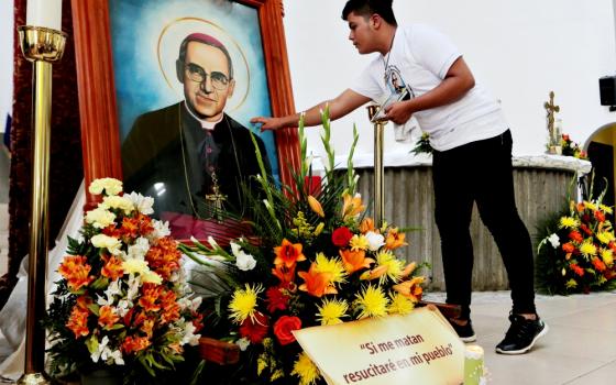 A young man touches a picture of St. Óscar Romero during an Oct. 13 Mass at the Metropolitan Cathedral in Managua, Nicaragua. The Mass was celebrated for Romero and six other new saints canonized Oct. 14 at the Vatican. (CNS/Reuters/Oswaldo Rivas)