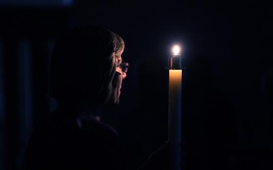 Benedictine Sr. Jennifer Mechtild Horner, prioress of the Sisters of St. Benedict of Beech Grove, Indiana, holds a candle symbolizing the light of Christ during a prayer service at the Our Lady of Grace Monastery Dec. 1, 2018. (CNS/Katie Rutter)