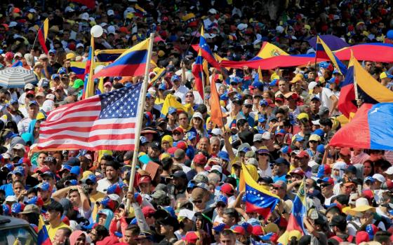 A U.S. flag waves in the crowd as protesters take part in a rally against Venezuelan President Nicolás Maduro's government in Maracaibo Jan. 23. (CNS/Reuters/Isaac Urrutia)