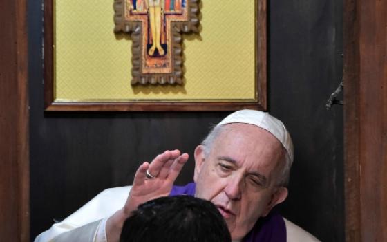 Pope Francis hears the confession of a priest at Rome's Basilica of St. John Lateran in March 2019. (CNS/Vatican Media)