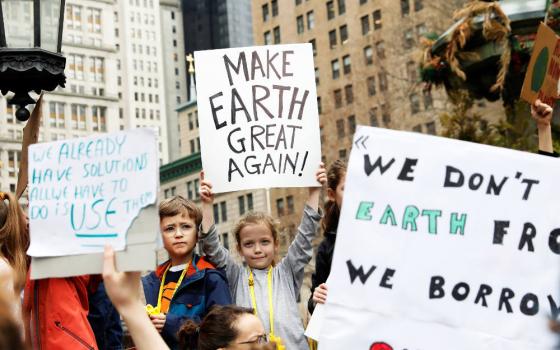 Students hold signs in New York City March 15, 2019, to demand action on climate change. Students from around the world are participating in the "strike." (CNS photo/Shannon Stapleton, Reuters)