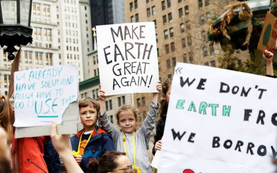 Students hold signs in New York City March 15, 2019, to demand action on climate change. Students from around the world are participating in the "strike." (CNS photo/Shannon Stapleton, Reuters)