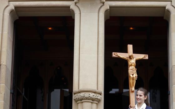 A young woman leaves St. Mary's Cathedral after a Mass in Sydney in 2013. (CNS/Reuters/Daniel Munoz)