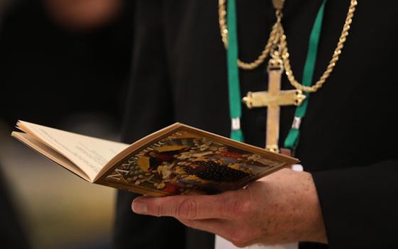 A bishop prays on the first day of the annual general assembly of the U.S. bishops' conference June 11, 2019, in Baltimore. (CNS /Bob Roller) 