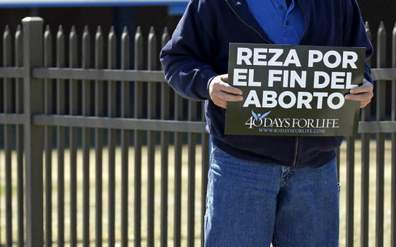 A Spanish-language sign that reads, "Pray for the end of abortion," is seen at a vigil near the entrance to a Planned Parenthood center in Smithtown, New York, March 26. (CNS/Gregory A. Shemitz)