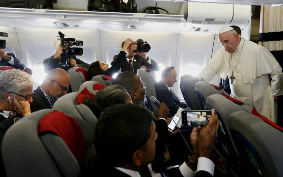 Pope Francis answers questions from journalists aboard his flight from Antananarivo, Madagascar, to Rome Sept. 10. (CNS/Paul Haring)